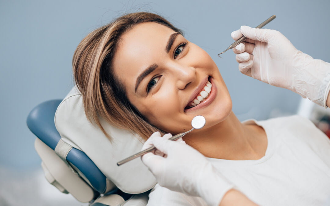 portrait of young woman with perfect smile in dental office, come to regular dental check-ups